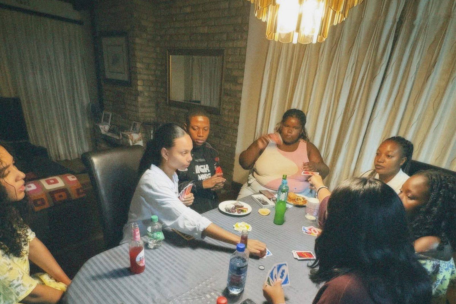 Friends playing cards around a kitchen table